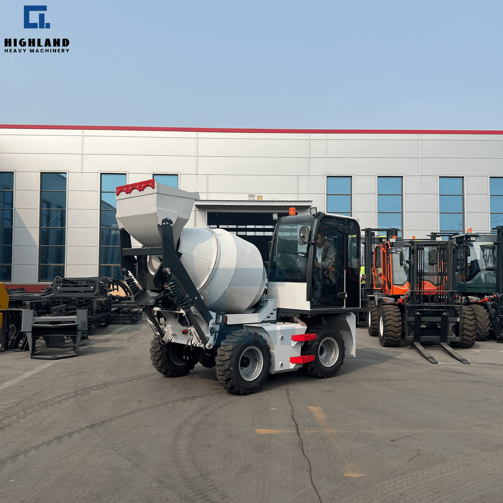 HIGHLAND HEAVY MACHINERY ultra-compact 0.8m³ self loading concrete mixer truck in white with red accents, parked in a factory yard next to other heavy equipment.