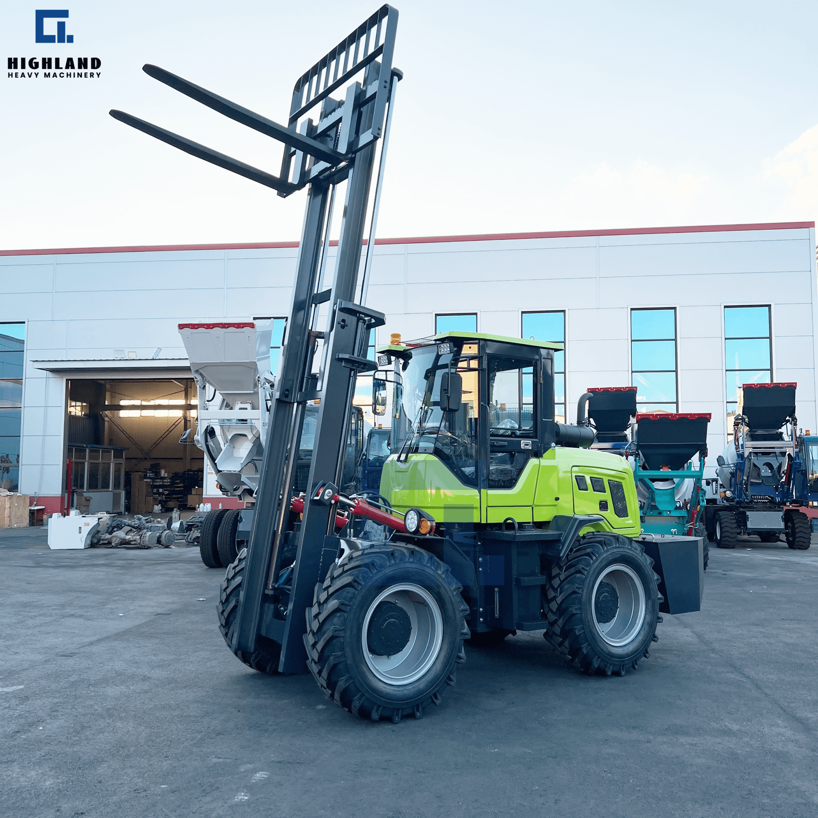 HIGHLAND HEAVY MACHINERY green rough terrain forklift with forks fully raised to maximum height, positioned in a service yard, demonstrating high-reach lifting capability and service inspection readiness.