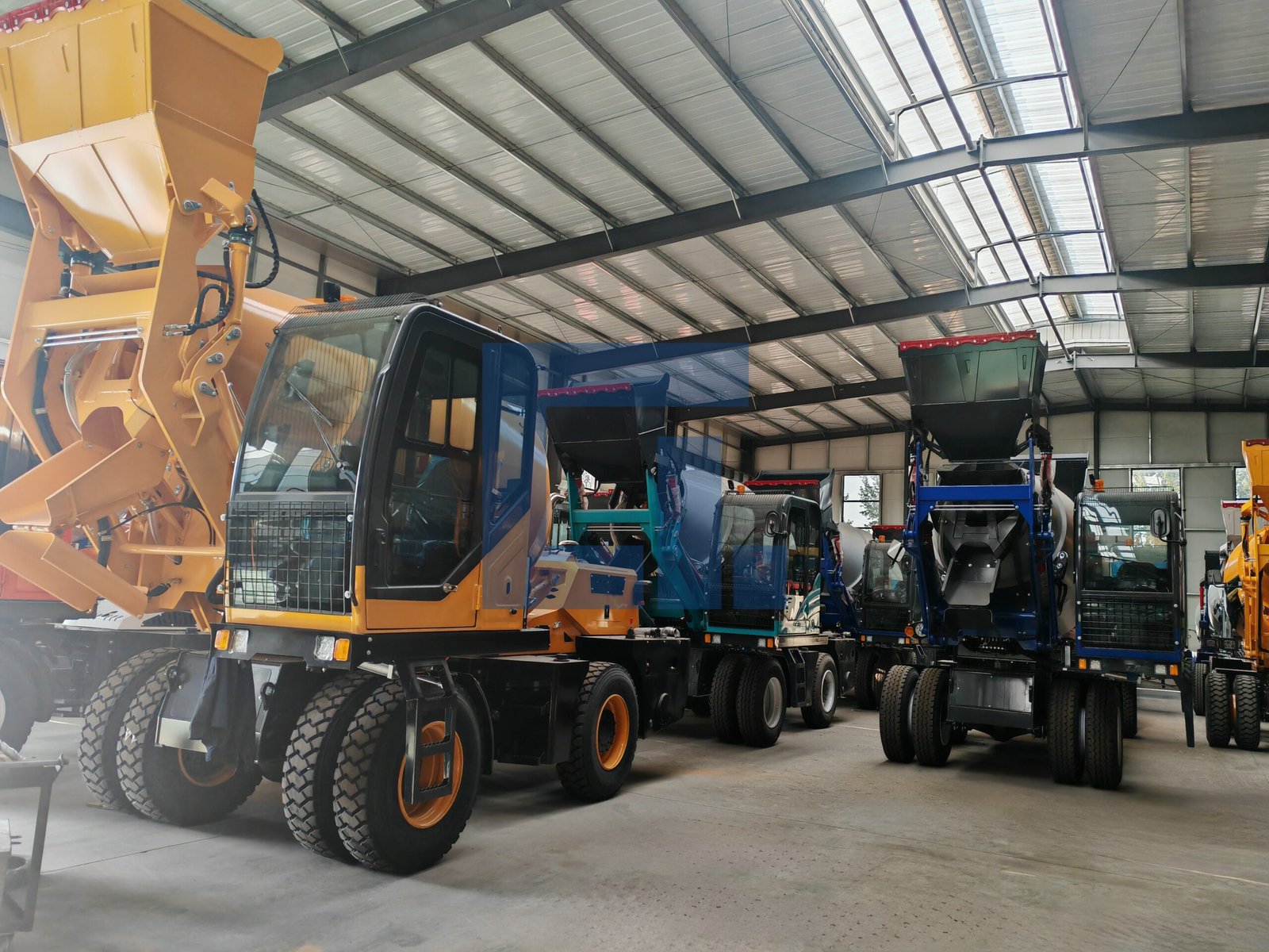 HIGHLAND HEAVY MACHINERY indoor factory lineup of self loading concrete mixer trucks in yellow and blue, with a rough terrain forklift in the background, showcasing large-scale production capacity and ready inventory for the About Us page.