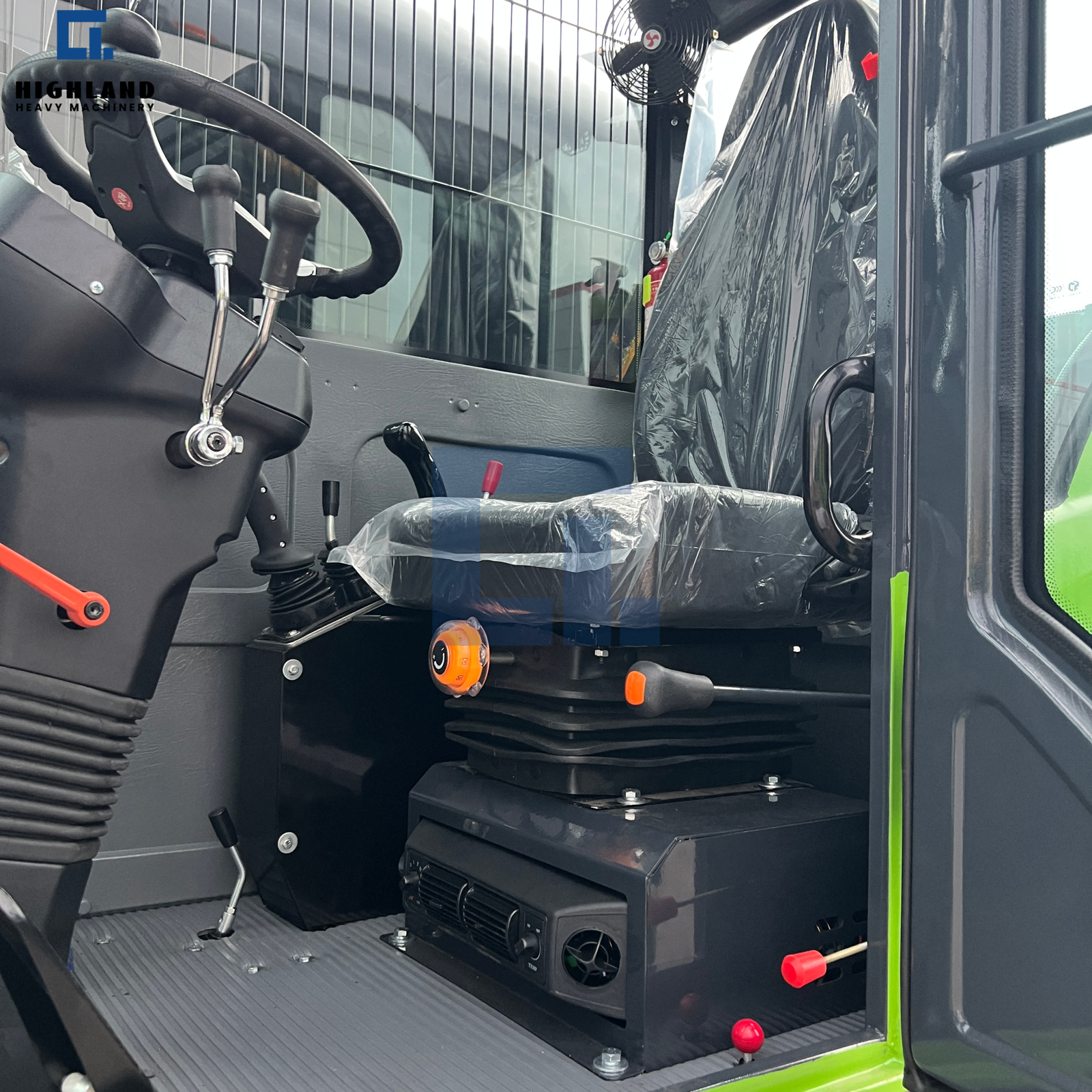HIGHLAND HEAVY MACHINERY self loading concrete mixer truck operator cabin interior, featuring a brand-new seat with protective film, steering wheel, control levers, and a floor-mounted air conditioning unit for all-weather comfort and precise control.