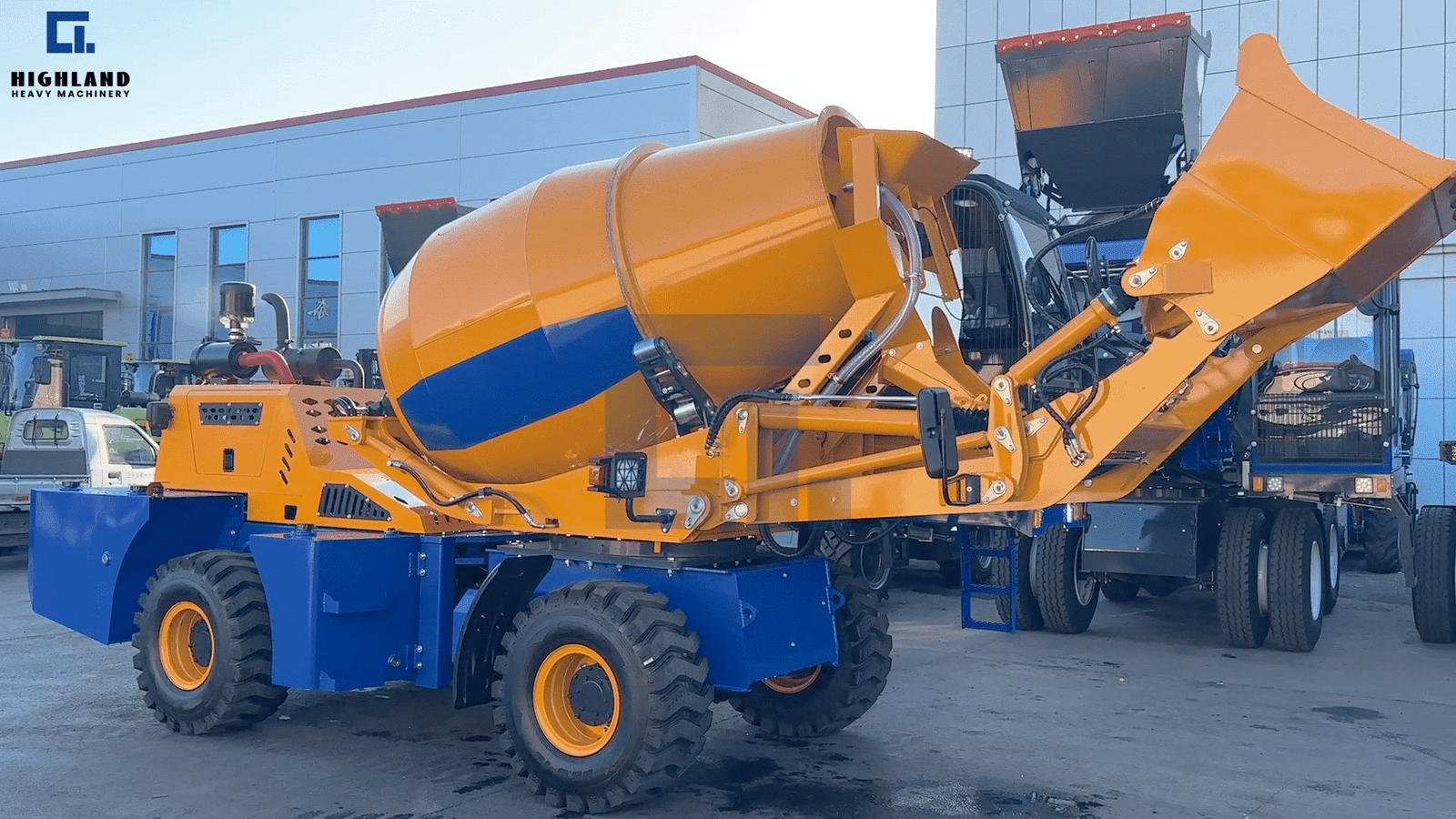 HIGHLAND HEAVY MACHINERY 2m³ yellow and blue self loading concrete mixer truck with high-tip lifting bucket raised, demonstrating high-discharge efficiency for parameter evaluation.