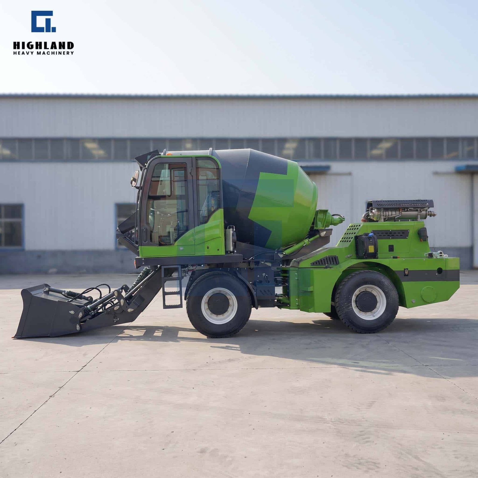 HIGHLAND HEAVY MACHINERY bright green self loading concrete mixer truck with a black mixing drum and front loader bucket resting on the ground, parked in a factory yard.