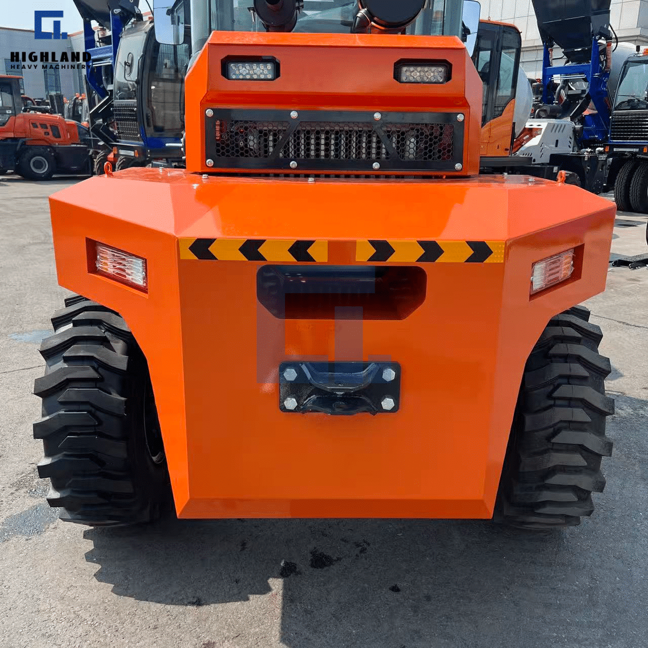 HIGHLAND HEAVY MACHINERY orange off-road forklift rear view, showcasing a heavy-duty cooling grille, bright LED tail lights, rear tow hitch, and high-visibility yellow-black safety chevron for optimal site safety.