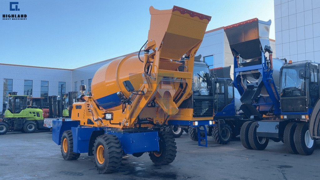 HIGHLAND HEAVY MACHINERY yellow and blue self loading concrete mixer trucks parked side-by-side, with the yellow unit's high-tip bucket raised, showcasing key configurations and color options for buyers to compare and evaluate.